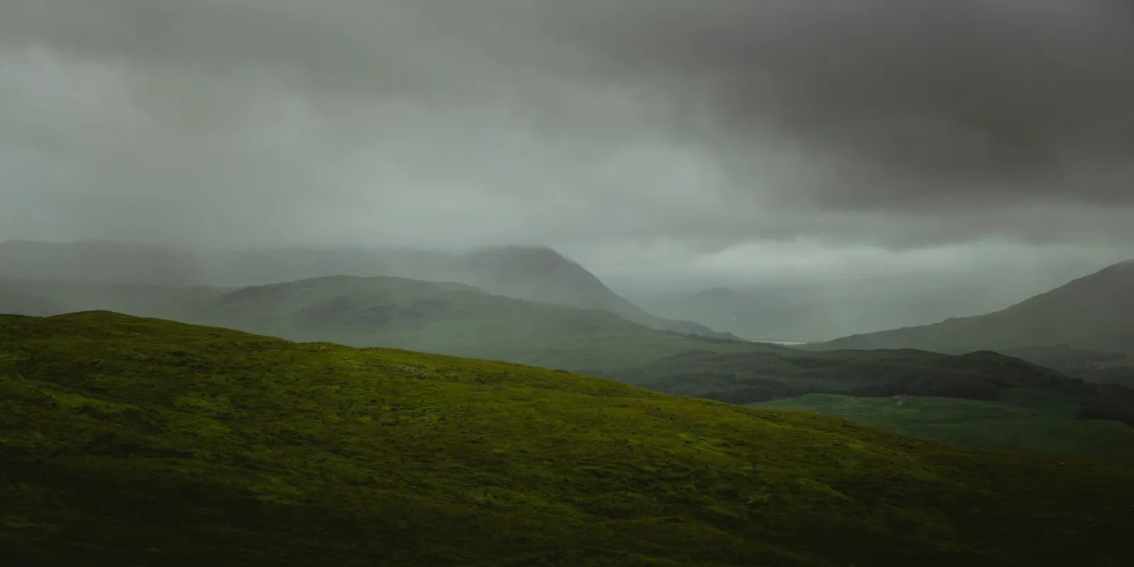 Moody green hills under a low sky